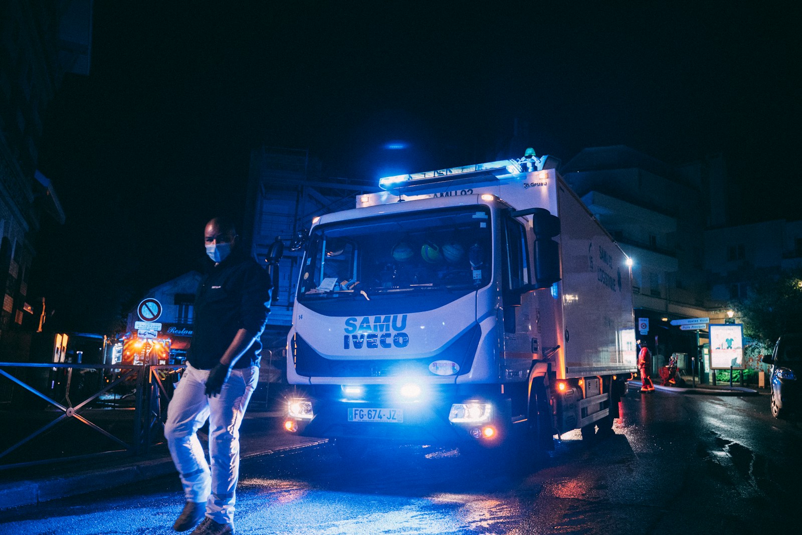 a man standing next to a truck on a street, trucking, fleet safety